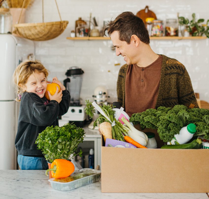 Man and boy laughing together, enjoying the benefits of good health